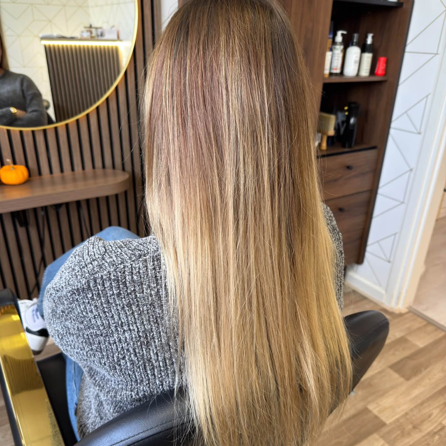 Lang haar met een kleurverloop van donkerblond naar honingblond, in de salon